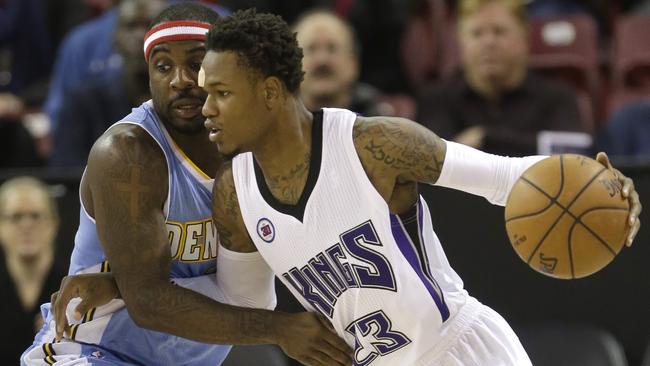 Denver Nuggets guard Ty Lawson, left, tries to stop the drive of Sacramento Kings guard Ben McLemore.