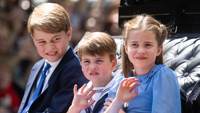 Prince George, Prince Louis and Princess Charlotte of Cambridge ride in a carriage during Trooping The Colour in 2022. Picture: Samir Hussein/WireImage