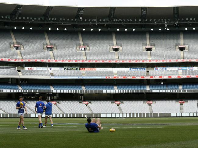 West Coast Eagles players warm up at am empty MCG. Picture: Getty