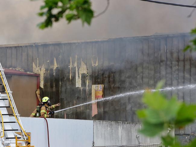 More than 60 firefighters are battling the blaze. Picture: Hamish Blair