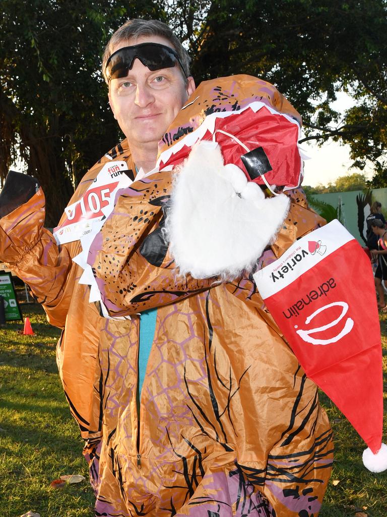 Chris Chase in his dinosaur outfit at the Darwin Santa Fun Run in July at Mindil Beach. Picture Katrina Bridgeford