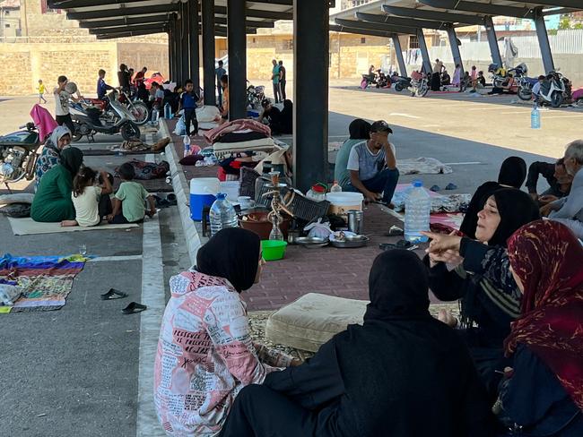 People, who fled their homes in the south of Lebanon, take refuge in a car park in the southern city of Sidon. Picture: AFP