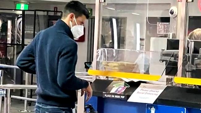 Novak Djokovic at Melbourne airport after handing over his passport … only to be denied entry to Australia on Thursday. Picture: 9NEWS