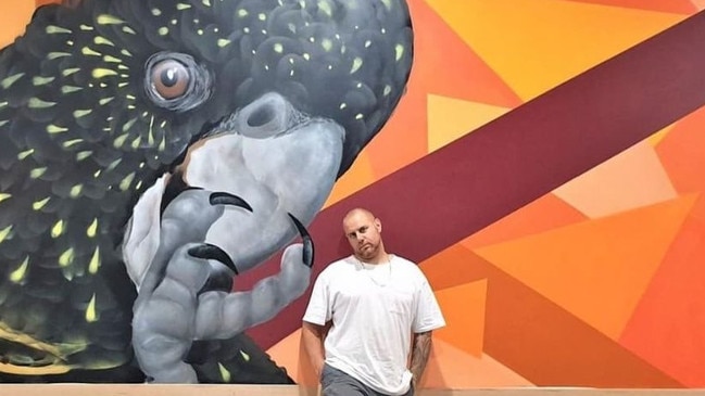 Brisbane artist Daniel Krause, in front of one of his murals. PHOTO: Supplied