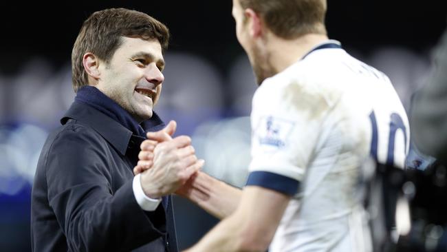 Tottenham's manager Mauricio Pochettino celebrates with Harry Kane, right, at the end of the English Premier League soccer match between Manchester City and Tottenham Hotspur's at the Etihad Stadium in Manchester, England, Sunday Feb. 14, 2016. Tottenham won 2-1. (AP Photo/Jon Super)