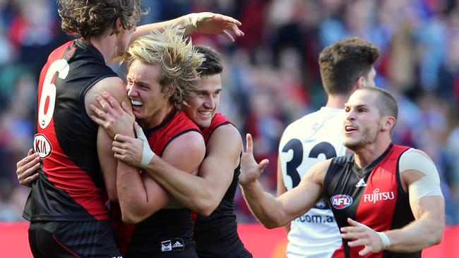 Essendon players enjoy their win against Melbourne. Picture: Alex Coppel