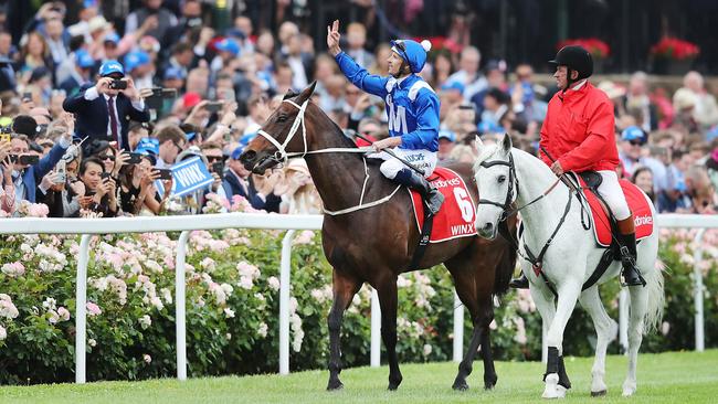 Jockey Hugh Bowman waves to fans after Winx’s 2018 Cox Plate victory at The Valley. Picture: Michael Dodge / Getty Images