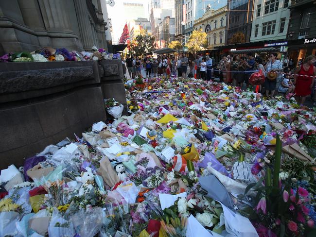 A flower memorial in Bourke St on Sunday evening. Picture: David Crosling