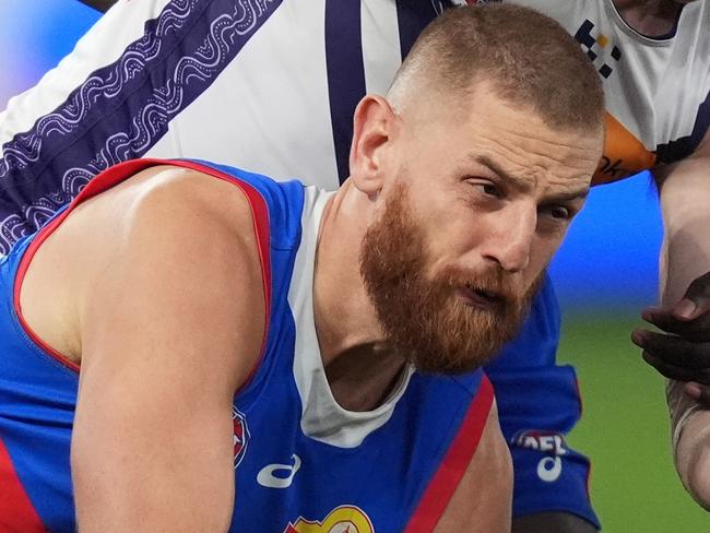 MELBOURNE, AUSTRALIA - JUNE 15: Liam Jones of the Bulldogs handballs under pressure from Josh Treacy of the Dockers during the round 14 AFL match between Western Bulldogs and Fremantle Dockers at Marvel Stadium, on June 15, 2024, in Melbourne, Australia. (Photo by Daniel Pockett/Getty Images)