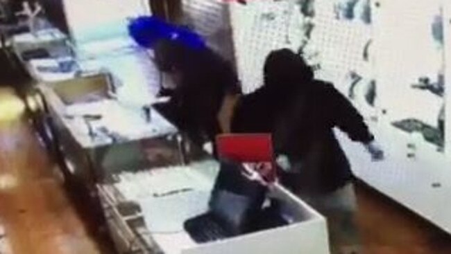 The robbers used a machete to threaten staff in the shop.