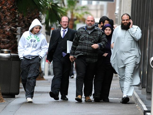 Bilal Khazal, on far right, is flanked by family and supporters outside the NSW Supreme Court, Sydney.