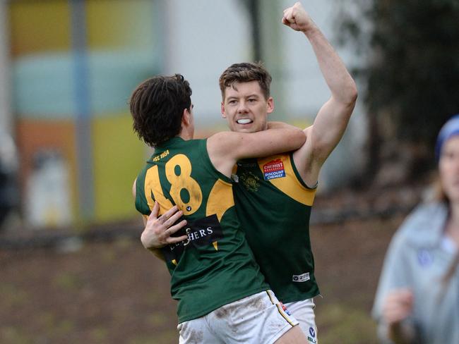 Jake Steinhart (right) celebrates a goal from the boundary in the dying minutes for Old Trinity against De La Salle in 2018. Picture: AAP/ Chris Eastman