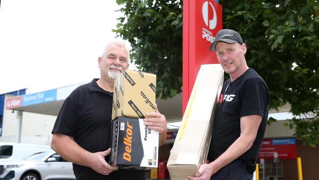 Business owners Glenn Rabbas and Chad Talbot with parcels at the soon-to-shut North Geelong Business Centre. Picture: Alan Barber