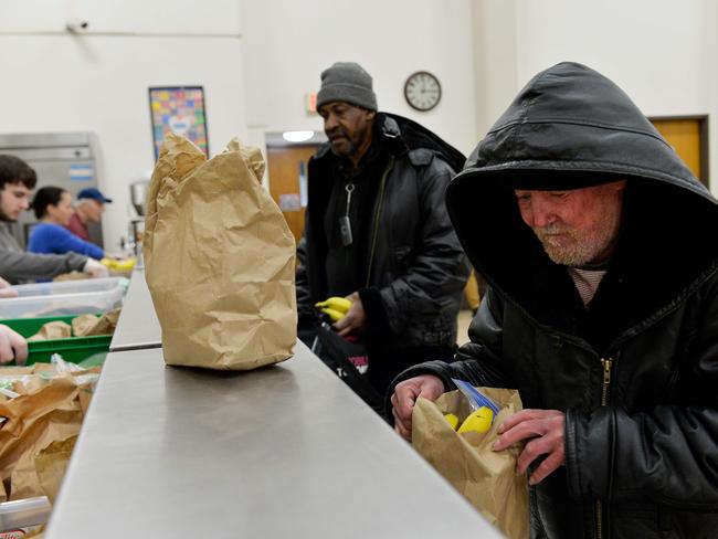 FALLOUT: Guests receive their meals in lunch bags at My Brother's Table soup kitchen in Lynn, Massachusetts Picture: Joseph Prezioso/AFP