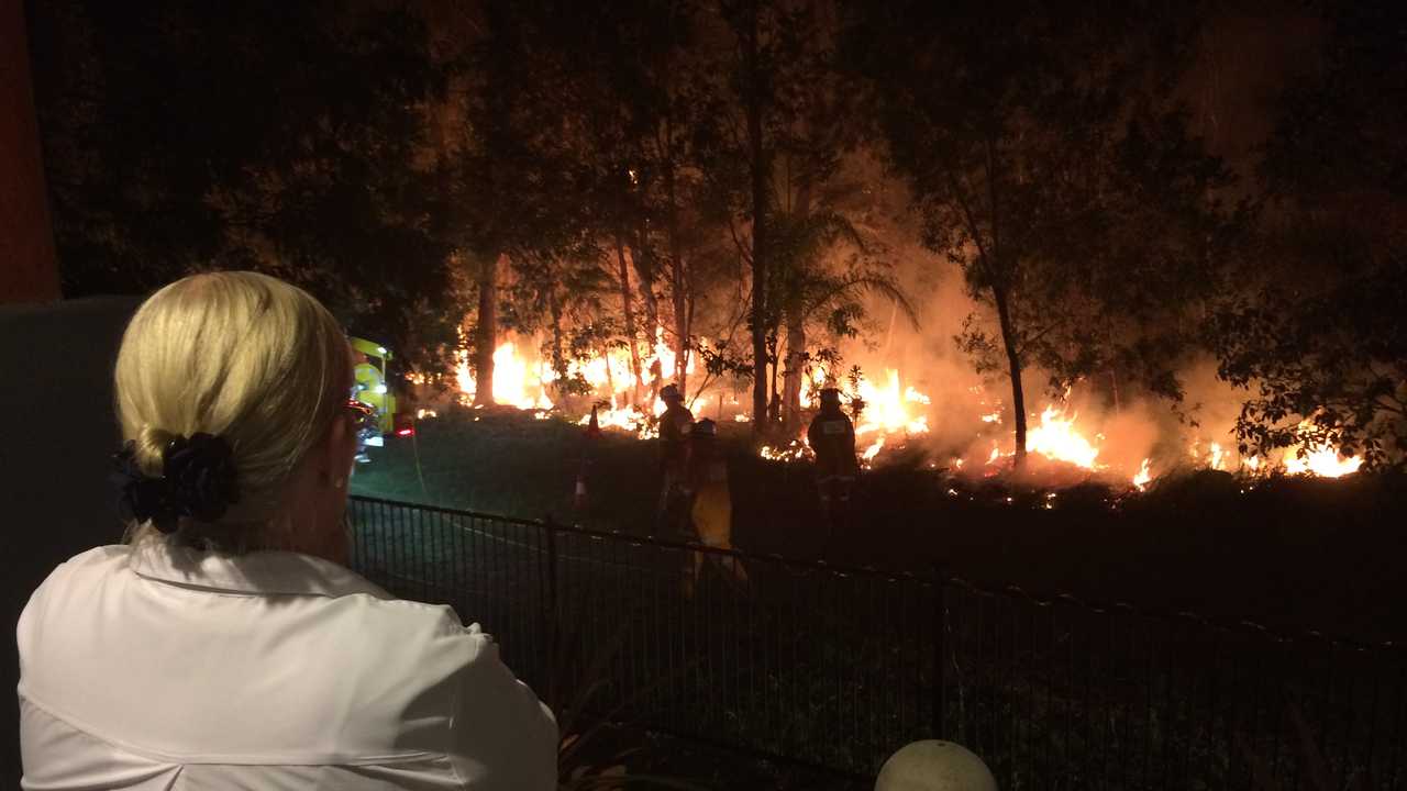 Roz Stuhmcke watches on as crews put in a back burn metres from her fence