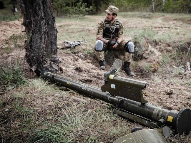 A Ukrainian soldier sits next to an anti-aircraft missile while taking some rest near Lyman, eastern Ukraine. Picture: Yasuyoshi Chiba / AFP