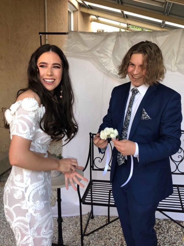 Lukasz presents Chelsea with a corsage for his Year 12 formal in 2018. Picture: Supplied by family