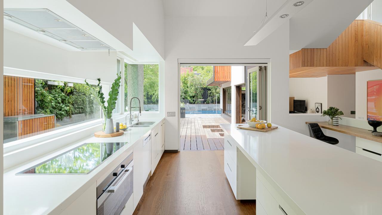 Bi-fold doors lead from the kitchen to outdoors.