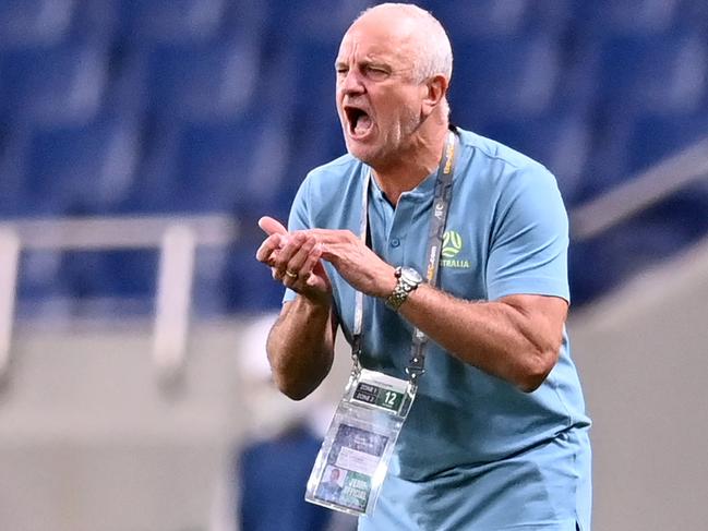 Australia's head coach Graham Arnold speaks to his players during the 2022 Qatar World Cup Asian Qualifiers group B football match between Japan and Australia, at Saitama Stadium in Saitama, on October 12, 2021. (Photo by CHARLY TRIBALLEAU / AFP)