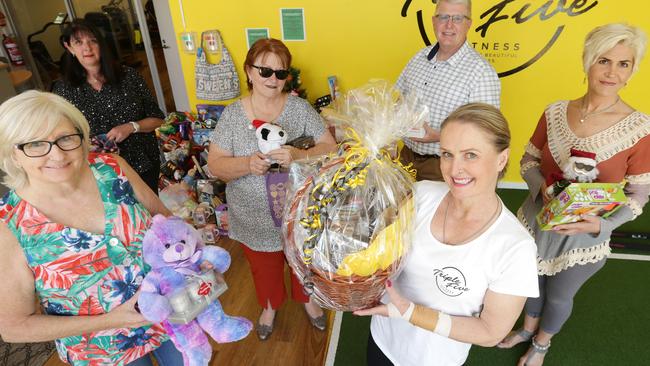 Kay Rimaldo (L) and volunteers Sara Simon, Pauline Alvarez, Cr Jim Magee, Ramona Kastrupo and Ashley Kahan with the toys and donated items under the drop off point at Triple Five gym Bentleigh. Norm Oorloff