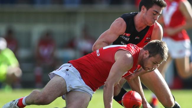 North’s Jay Shannon is tackled by West Adelaide’s Jack Agostino. Photo: Matt Turner.