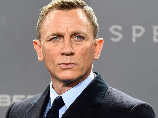 (FILES) In this file photo taken on October 28, 2015 British actor Daniel Craig poses for photographers at a photocall for the new James Bond film 'Spectre' in Berlin. - New James Bond footage from historic Hollywood studio MGM shook and stirred the movie theater industry's CinemaCon summit in Las Vegas August 24, 2021, as executives struck a defiant note about the future of the big screen. (Photo by TOBIAS SCHWARZ / AFP)