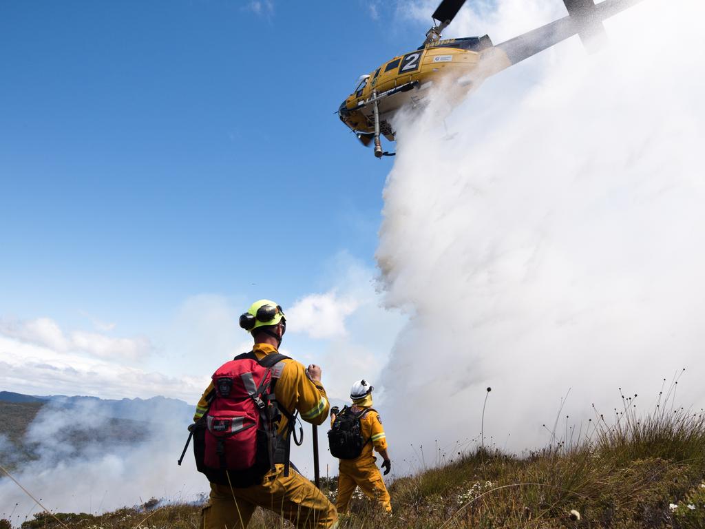 Tasmania Fire Service firefighers with aerial waterbombing at the Gell River fire. Picture: WARREN FREY/TASMANIA FIRE SERVICE