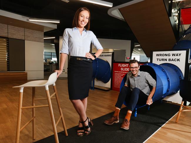 Sam Aldenton and Alastair Emmett work at Flight Centre Travel Group’s new global headquarters, which features slides, massage and spray tanning rooms. Picture: Jono Searle