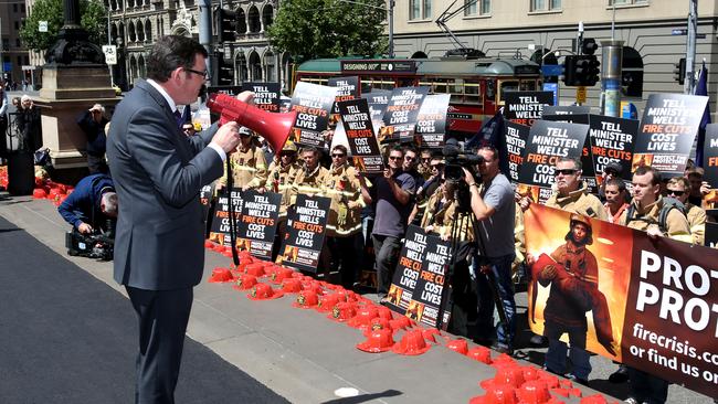 The Parliament House steps will be covered in red fire helmets as firefighters protest the continued failure of the Napthine Government to provide the 342 extra CFA firefighters promised after Black Saturday. Opposition leader Daniel Andrews addresses the crowd on the steps of Parliament.