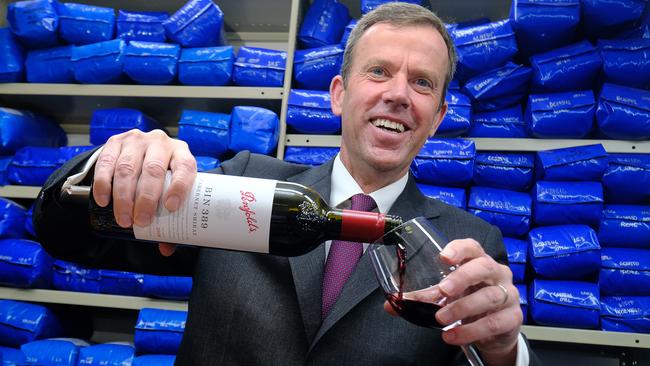 Trade Minister Dan Tehan puts a glass of wine after giving a press conference about signing the trade agreement with India, in Melbourne. Picture: Luis Enrique Ascui