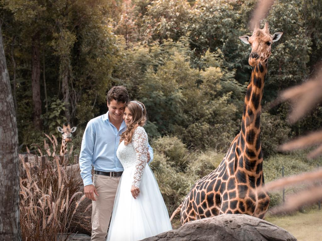 Chandler Powell and Bindi Irwin on their wedding day. Chandler has his arm around Bindi. Picture: Kate Berry