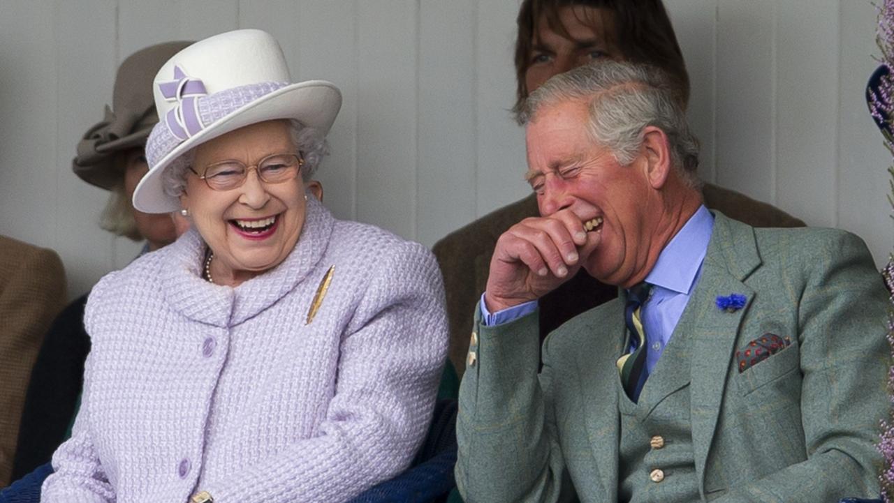 The Queen and Prince Charles laugh while watching the children's sack race as they attend the 2012 Braemar Highland Gathering. Picture: Indigo/Getty Images