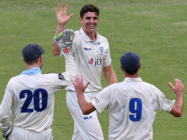 New South Wales bowler Sean Abbott (centre) celebrates after taking his fifth wicket in the final session.