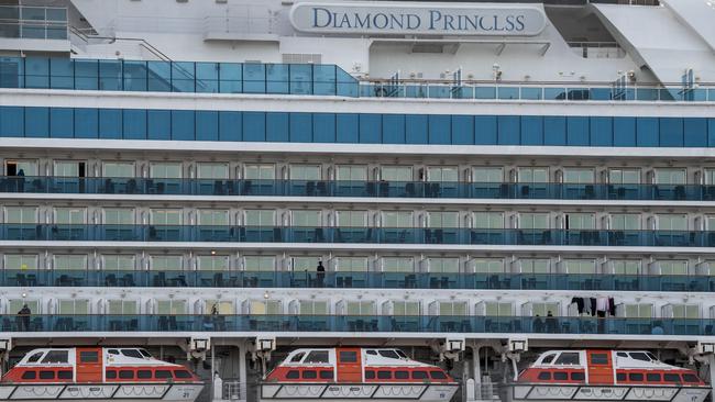 People stand on balconies on the Diamond Princess cruise ship while it is docked in quarantine. Picture: Getty Images