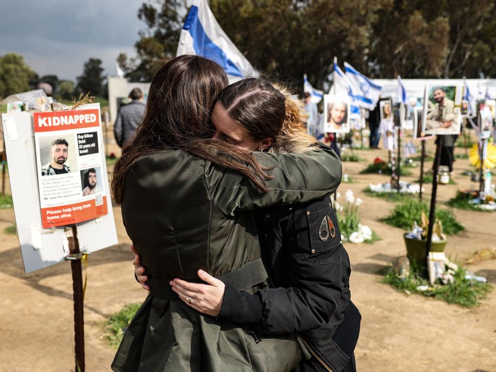 TOPSHOT - Two women react while visiting the site of the Supernova music festival near Kibbutz Reim, southern Israel, on February 19, 2024. Thousands of visitors in Israel have been flocking weekly to the site of the Supernova music festival, to pay their respects to the 364 people killed there by Hamas in the October 7 attacks. The Supernova festival saw the highest toll by far of the sites attacked when Hamas militants broke through from Gaza into southern Israel in an unprecedented attack, which resulted in the deaths of more than 1,160 people. In response, Israel launched a military campaign that has killed at almost 30,000 people in Gaza, mostly women and children, according to the Palestinian territory's health ministry. (Photo by RONALDO SCHEMIDT / AFP) / To go with 'Israel-Palestinians-conflict' by Michael BLUM #MER62