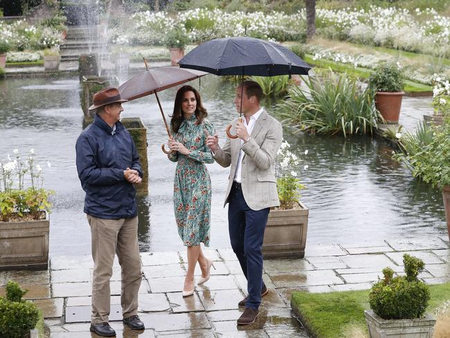 Britain's Prince William, right, and his wife Kate, Duchess of Cambridge are given a tour at the memorial garden in Kensington Palace, London. Picture: AP.