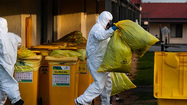 Workers remove bags of contaminated items from St Basil’s during the peak of the outbreak. Picture: Jason Edwards