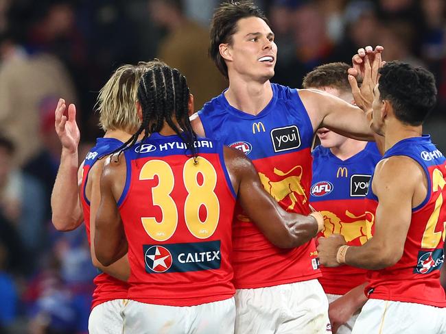 MELBOURNE, AUSTRALIA - JUNE 07: Eric Hipwood of the Lions is congratulated by team mates after kicking a goal during the round 13 AFL match between Western Bulldogs and Brisbane Lions at Marvel Stadium, on June 07, 2024, in Melbourne, Australia. (Photo by Quinn Rooney/Getty Images)