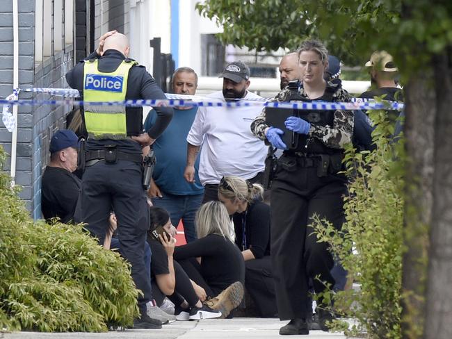 Police talk with Abdulrahim’s associates. Picture: Andrew Henshaw