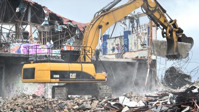 Demolition works started this week to knock down the derelict building on the Pacific Motorway service road south of Brisbane. Picture: John Gass