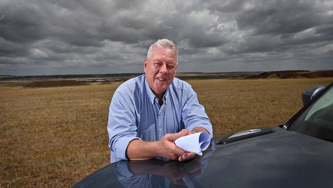 A frustrated John Wagner, holding site plans, on the area at his Wellcamp airport where he wants to immediately build a covid quarantine facility, at Toowoomba. Picture: Lyndon Mechielsen