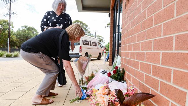 Fans Jan Macdonald and Meredith Lee leave flowers at Alberton Oval for Russell Ebert. Picture: Brenton Edwards