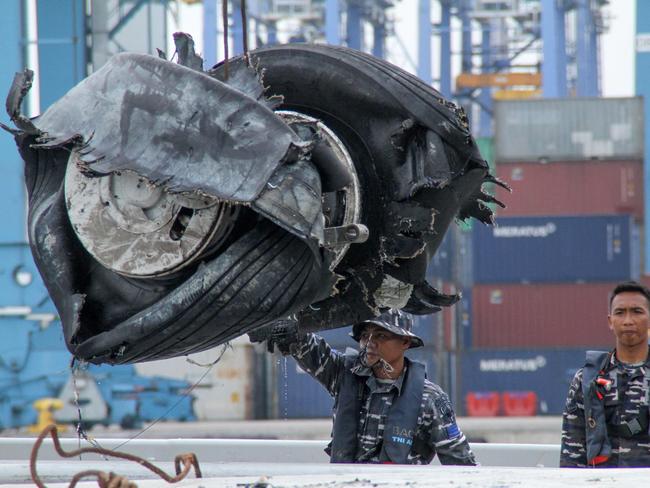 Members of an Indonesian rescue team unload a pair of tyres from the ill-fated Lion Air flight. Picture: AFP