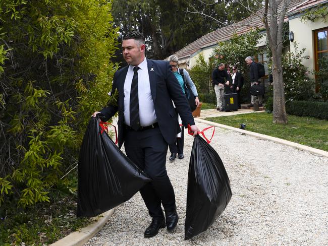 Australian Federal Police (AFP) officers are seen leaving a house believed to be of a former government media adviser during a raid in Canberra, Wednesday, September 4, 2019. (AAP Image/Lukas Coch) NO ARCHIVING