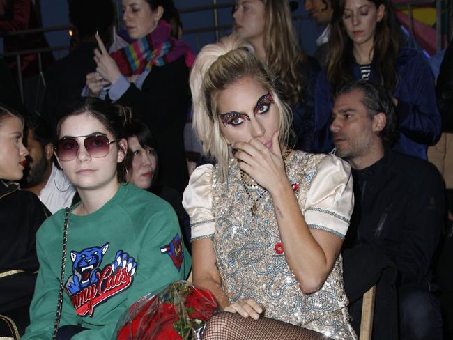 Lady Gaga attends the Tommy Hilfiger show in LA as rumoured boyfriend Christian Carino sits behind her. Picture Splash News