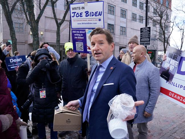 Democratic presidential hopeful, US Representative Dean Phillips, brings coffee to a Joe Biden Write-In Rally in Manchester, New Hampshire, on January 20, 2024. US President Joe Biden will not be on New Hampshire's January 23 primary ballot, but supporters are organizing a write-in campaign. (Photo by TIMOTHY A. CLARY / AFP)