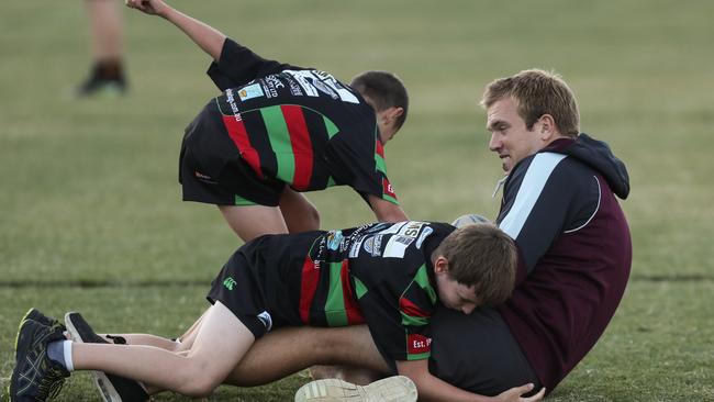 Manly’s Jake Trbojevic gets involved in some training drills with the Avalon juniors yesterday. Pictures: Julian Andrews