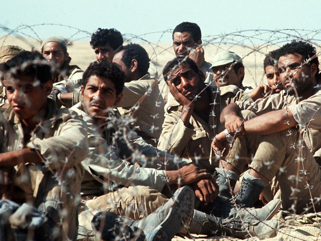 Egyptian Third Army soldiers, prisoners of war captured by Israel, sit behind barbed wire at a POW camp near the Suez Canal during the 1973 Arab-Israeli War on November 1, 1973. Picture: AFP