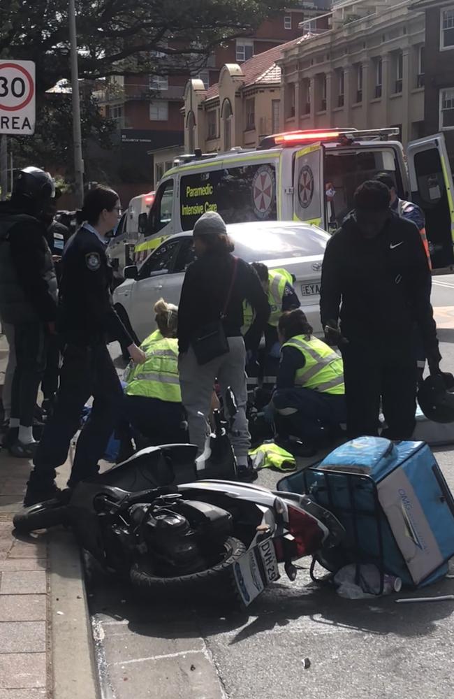 A scooter deliver rider suffered a serious leg injuries in a collision with a car on West Esplanade, Manly, on Wednesday. Picture: Jim O’Rourke