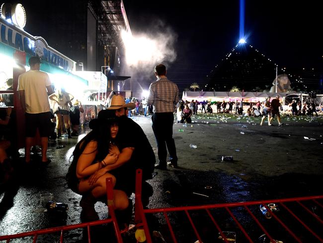 People take cover at the Route 91 Harvest country music festival. Picture: David Becker/Getty Images